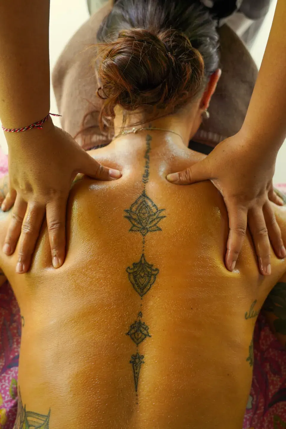 A therapist massaging a guest’s upper back