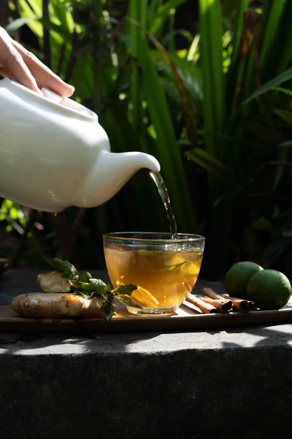 Pouring herbal tea into a glass at the spa