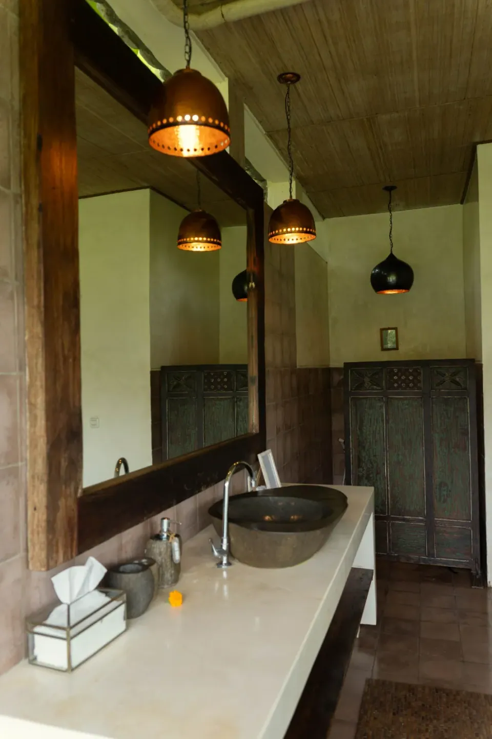 Pendant lights above a long bathroom counter